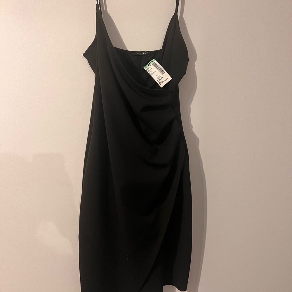 Black asymmetrical dress. Size large. Brand new. Never worn. Tag attached